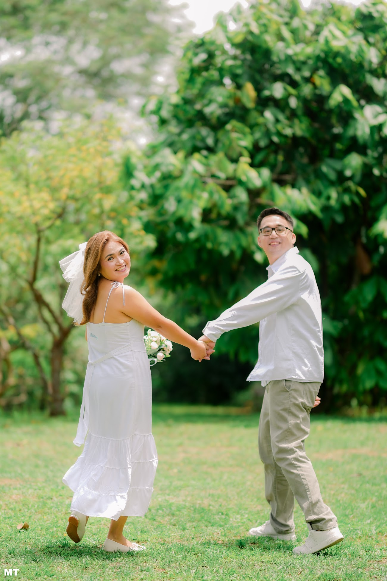 Laddie twirling while holding Paulo's hand on the lawn