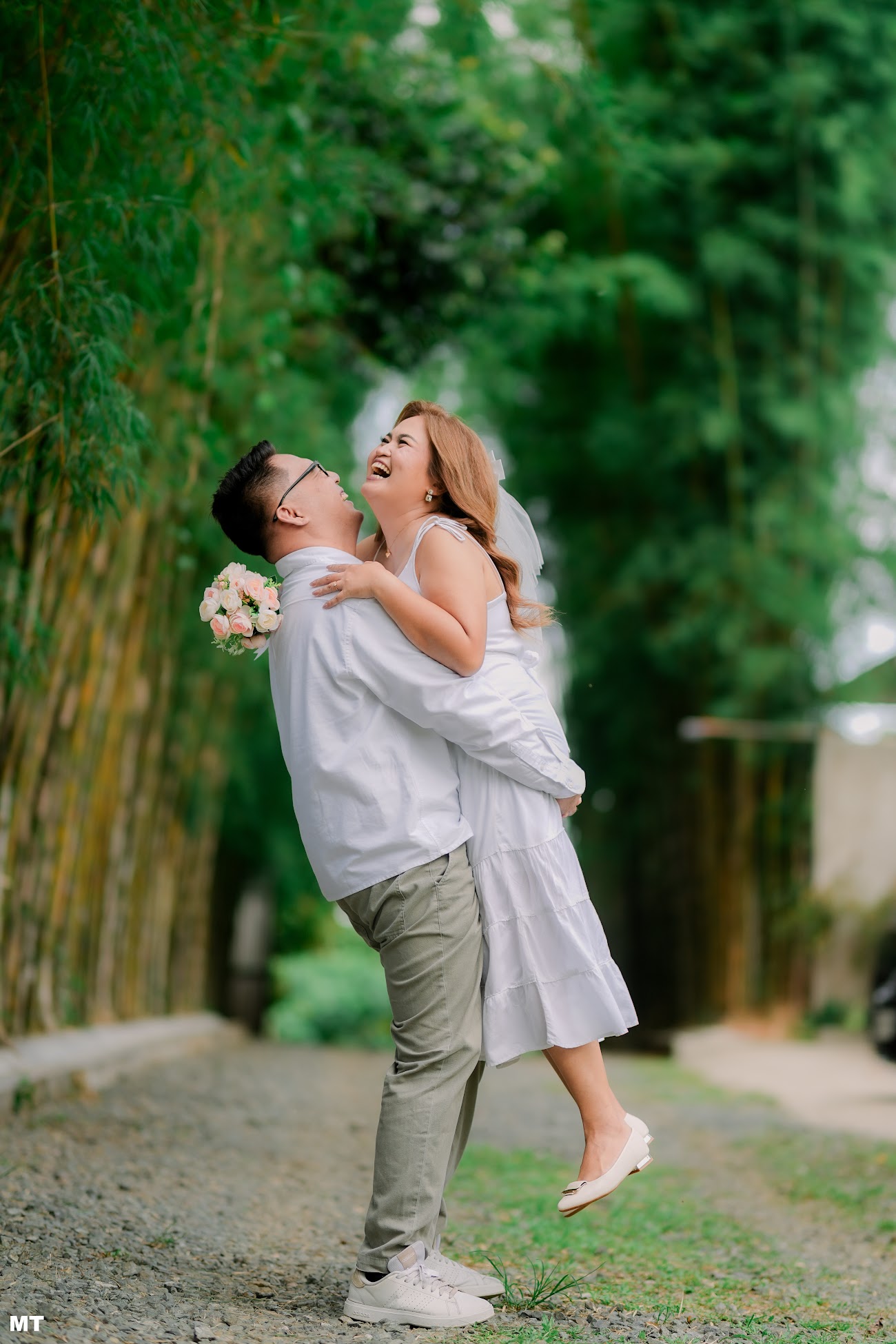 Paulo lifting Laddie on a bamboo-lined path